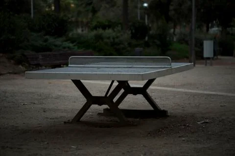 Deserted old table tennis table in an outdoor environment in low evening light Stock Photos