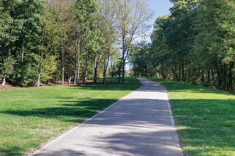 Deserted path in a green park Stock Photos