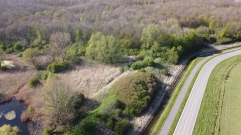 Deserted road in the spring, few passing cars filmed from above. Stock Footage 153124531