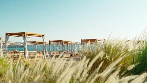 A deserted sandy beach with deserted beach tents. Absence of people on vacation. Stock Footage 341916252