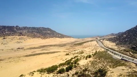 Deserted valley between hills with highway under blue sky Video stock 100420141