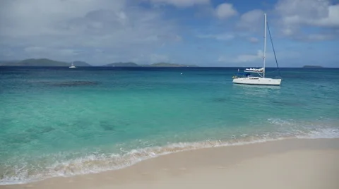 Deserted Virgin Gorda beach in the BVI with a sailboat 2 Stock Footage