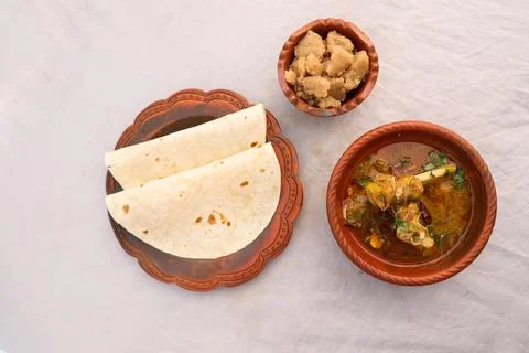 Desi breakfast Mutton nalli nihari, Halwa and chapatti served in dish isola.. Stock Photos