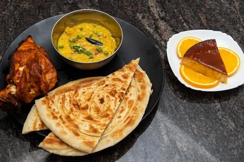 Desi breakfast Platter with chicken roast, dal and Caramel pudding served i.. 스톡 사진