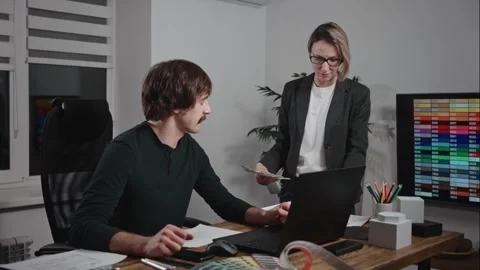 Design and architecture studio. A man and a woman are designers working with Stock Footage 297049521