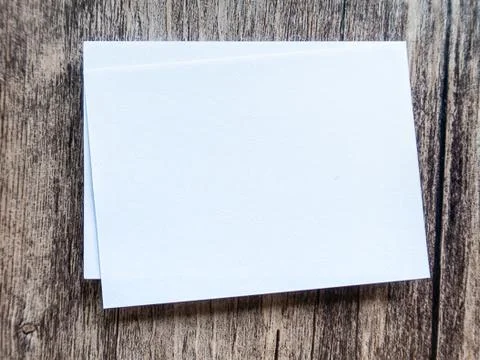 Design concept - perspective view of white business card on wood floor backgr Stock Photos