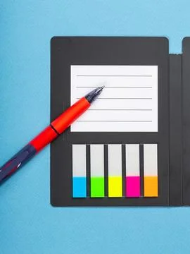 Design concept - top view of notepad with white sheets, bookmarks, binder and Stock Photos