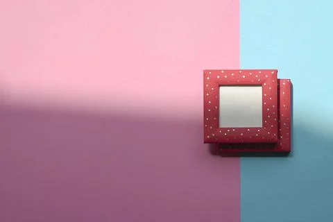 Design concept - top view of two red photo frames isolated on blue and pink b 스톡 사진