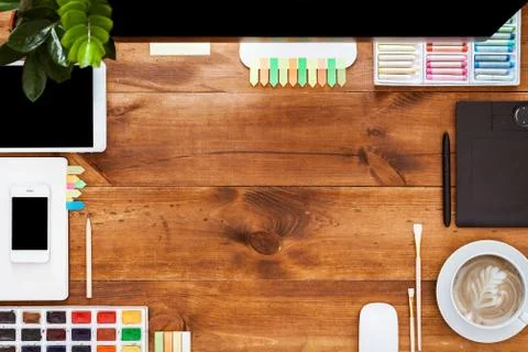 Design creative worktable concept, computer paints on brown wooden desk Stock Photos