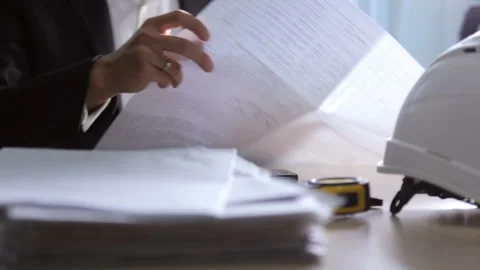 Design engineer working with drawings in the office Stock Footage 98277365