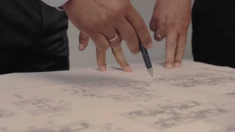 Design engineers are discussing a complex technical diagram drawn Stock Footage 212381019