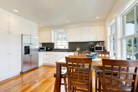 Design of kitchen room interior with white cabinets and black counter tops. T Stock Photos
