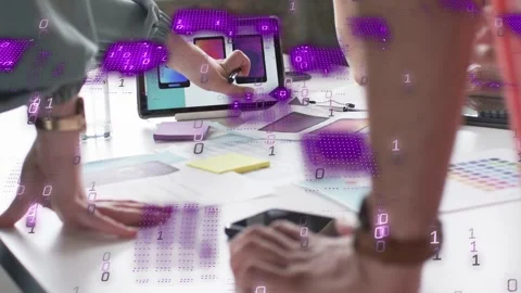 Design lead tapping tablet with stylus, team shifting mockups purple overlay Stock Footage 335466205