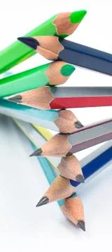 Design made with some different colored wood pencil crayons on white backgrou Stock Photos