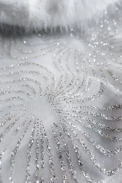 Design pattern on a fabric with silver thread detailing showing intricate s.. Foto stock