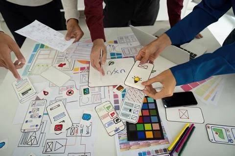 Design Process and Creative Input. Team examining design elements together to Stock Photos