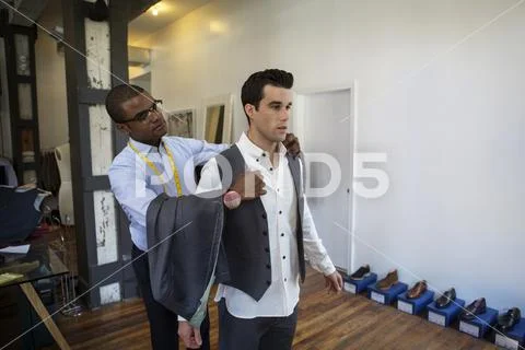 Design professional assisting customer at workshop Stock Photos