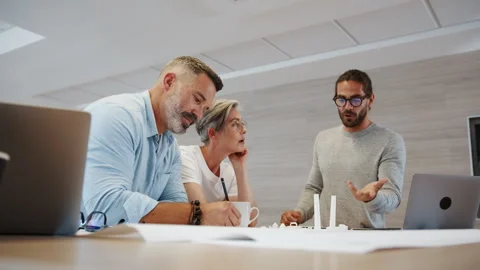 Design professionals combing their creativity for a wind energy project using bl Stock Footage 245637885