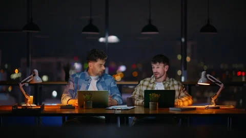 Design professionals working laptop shaking hands at dark office. Two developers Video stock 310606276