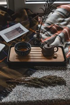 Design a Serene Tea Setup Enriched with Cozy Accents to Promote an Inviting Stock Photos
