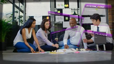Design team arranging sticky notes and mockups on floor, laptop input activating Stock Footage 333999810