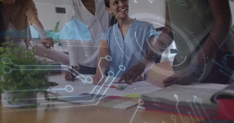 Design team marking up blueprint plans in modern studio, overlaying Stock-Footage 307442903