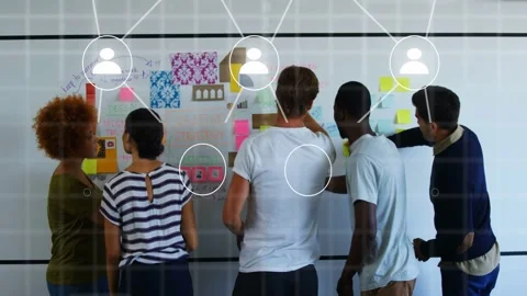 Design team pointing and writing on board notes, animating avatar icons into Stock Footage 333300794
