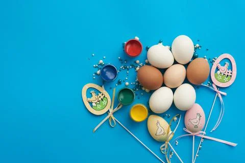 Design template for easter with eggs and paints on a blue background Stock Photos