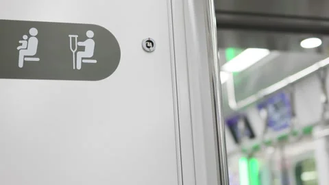 Designated priority seating signs train inclusion. Symbols remind passengers Video stock 323056236