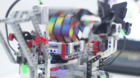 Designed for child modern robot collects Rubiks Cube Stock Footage 81787608