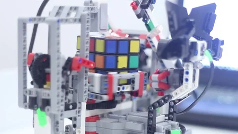 Designed for children modern robot collects Rubiks Cube Stock Footage 81787618