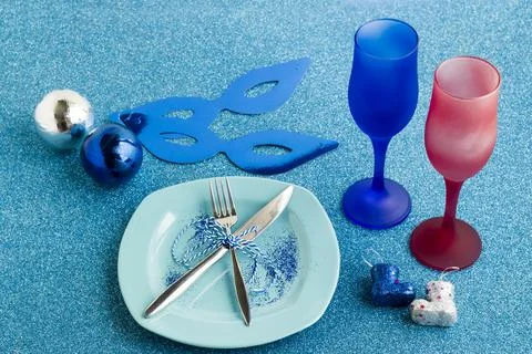 Designed Christmas Table with two blue champagne glasses and plate Stock Photos