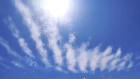 Designed clouds layer in blue sky with sunlight Stock Photos
