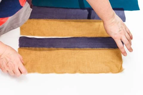 Designer arranges strips of fabrics for patchwork Stock Photos