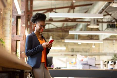 Designer with bright lips reading e-mail on smartphone Stock Photos
