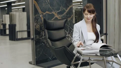 Designer browsing tile catalog in a salon Video stock 276620326
