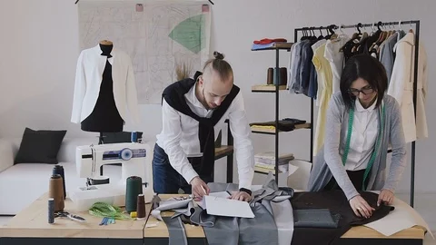 The designer of clothes and dressmaker develops a new collection of clothes at 스톡 동영상 92336541