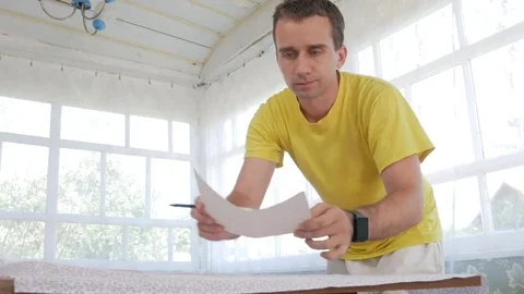 A designer clothes designer notes and cuts fabric details with scissors. Very Stock Footage 78620510