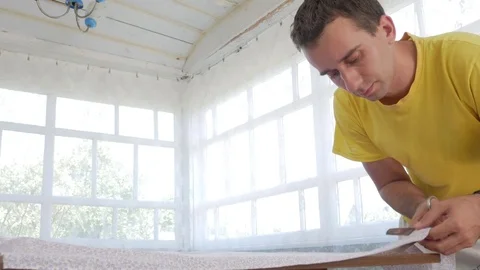 A designer clothes designer notes and cuts fabric details with scissors. Very Stock Footage 78620727