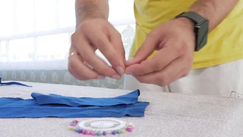 A designer clothes designer notes and cuts fabric details with scissors. Very Stock Footage 78621513