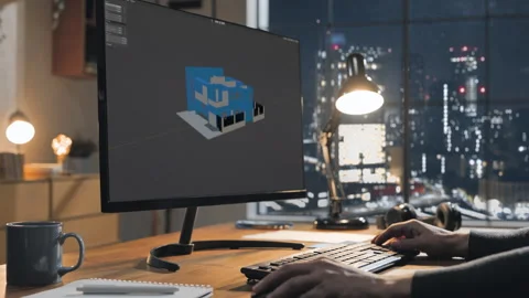 Designer at computer designs new house building at the office desk Stock Footage 318906084