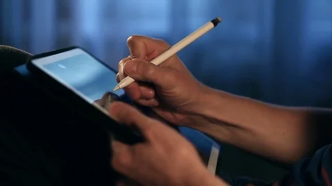 Designer create a sketch on his tablet using a stylus at home. Video stock 82361429