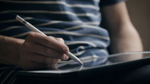 Designer create a sketch on his tablet using a stylus at home Video stock 94974281