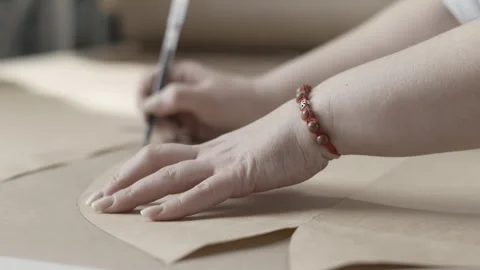 Designer creates patterns in a fashion studio with precision and creativity in Stock Footage 277177435