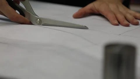Designer cuts white paper clothes template with scissors Stock Footage 136400514
