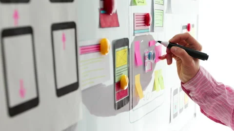 A designer is developing a web application for mobile phones. User experience. Stock Footage 157477658