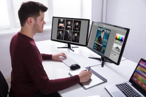 Designer Drawing On Graphic Tablet While Working On Computer Stock Photos