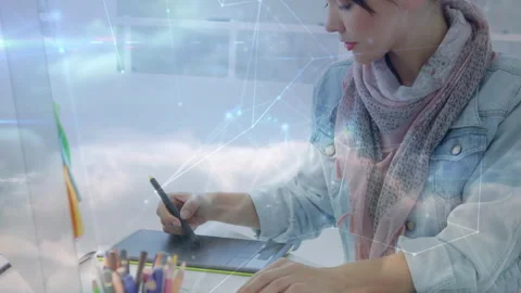 Designer drawing on tablet stylus causing cloud or network overlay camera Stock Footage 331085297