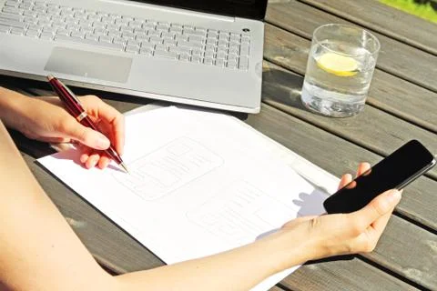 Designer drawing a wireframe for mobile web application Stock Photos