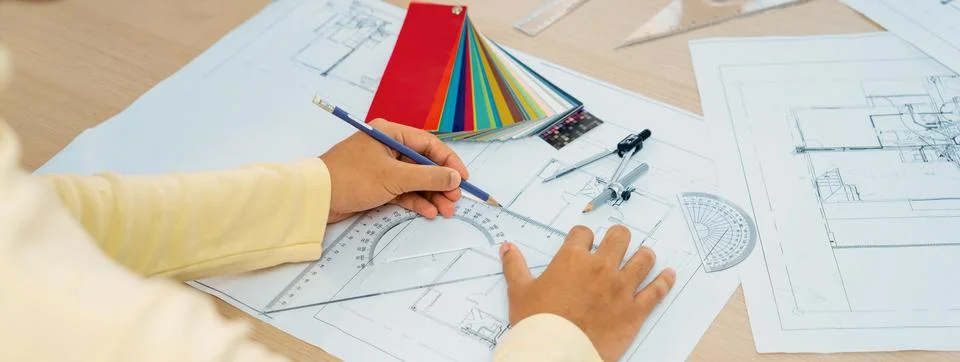 Designer draws blueprint while manager shows the mistake point. Variegated. Stock Photos
